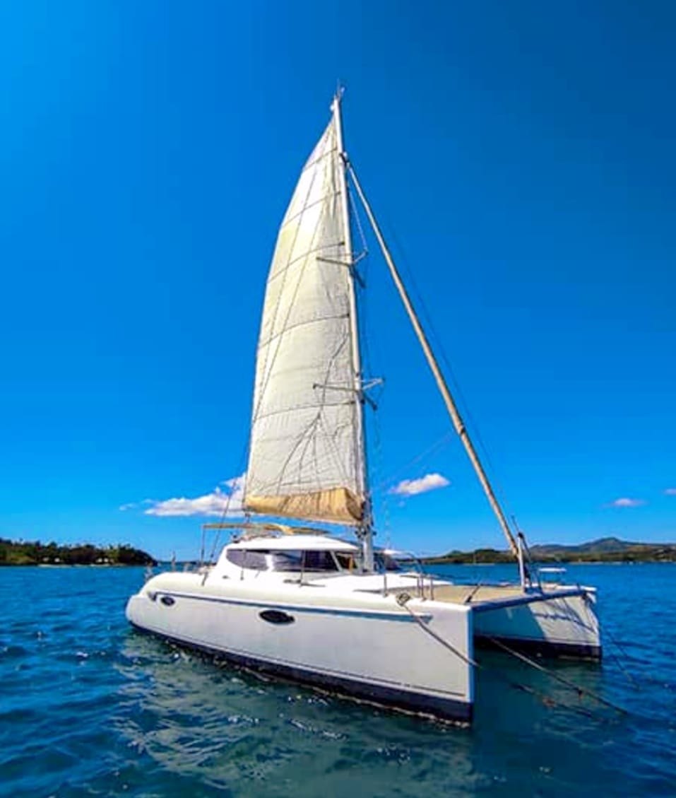 The Adventurer catamaran under sail off Nosy Be
