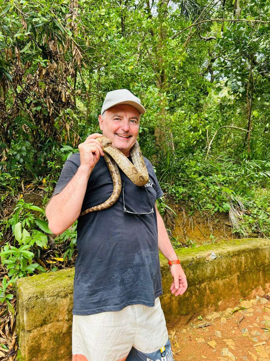 A visitor wearing the harmless tree boa