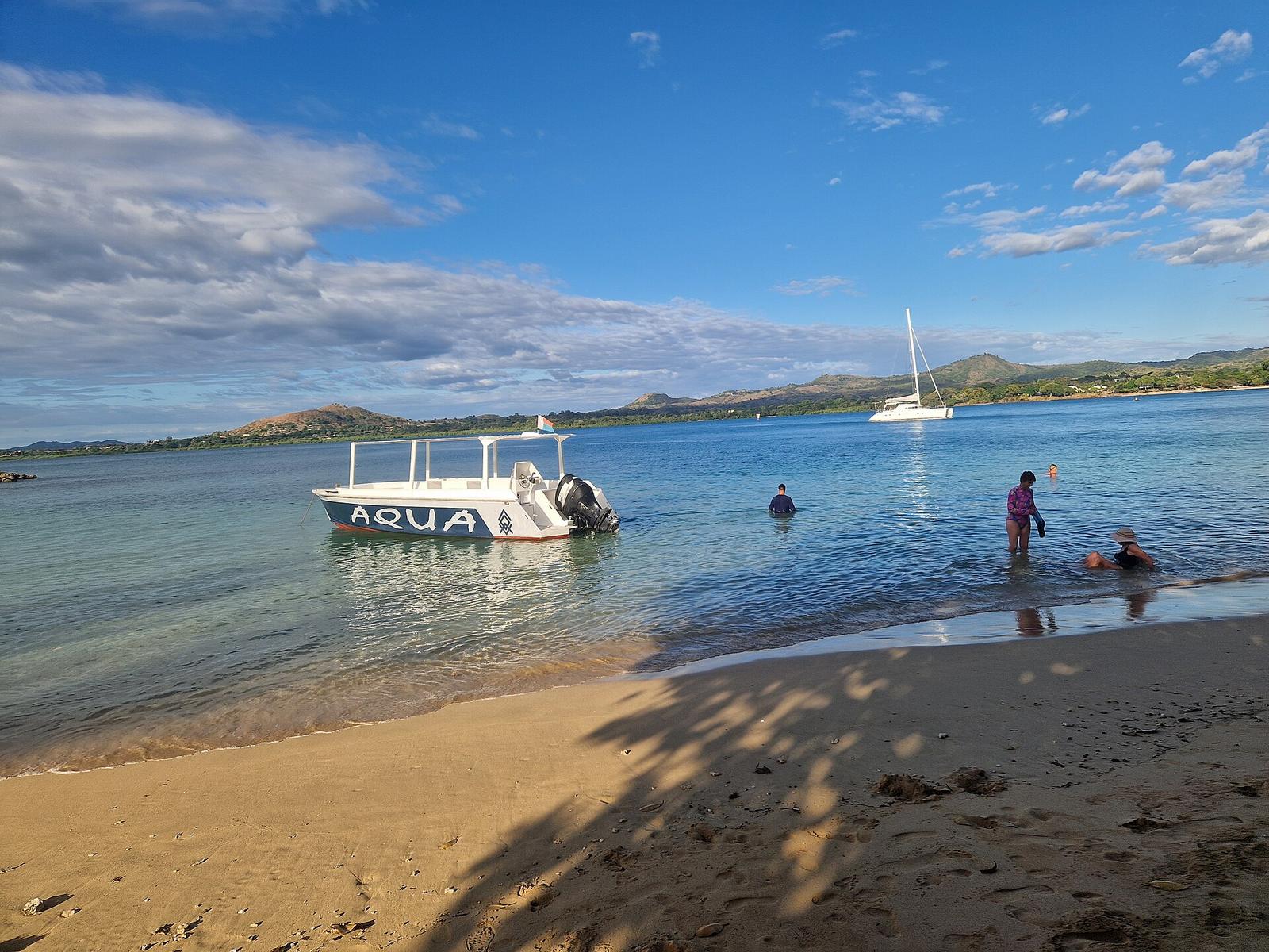 Our boat moored off a Nosy Sakatia beach while guests swim