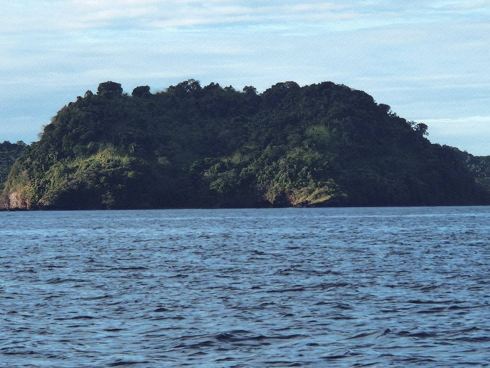 The green forested hill of Nosy Sakatia from the water